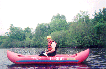 Dad in an inflatable kayak on the Wolf River